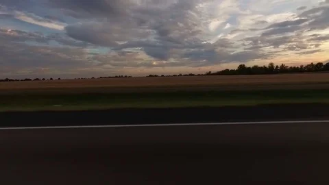 Driving by Farm Fields at Sunset Side View  Stock Footage 80778069