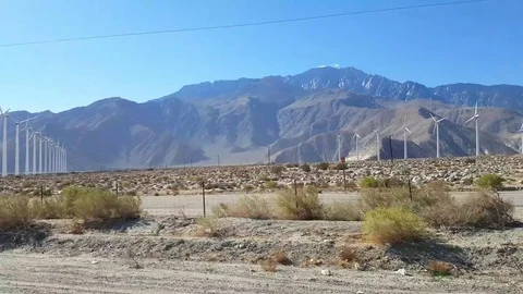Driving of a field full of wind power generators, on interstate 10, just ou.. Stock Footage 72758826