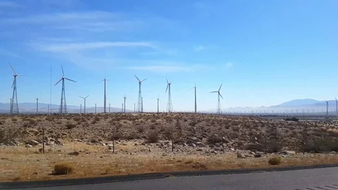 Driving at a field of wind power generators, on interstate 10, just outside.. Stock Footage 72751446