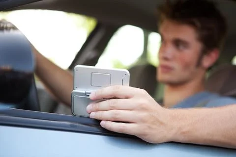 Driving: focus on cell phone Stock Photos