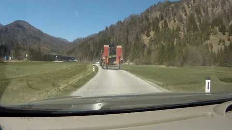 Driving on a forest road in austria behind a lowloader Stock Footage 127628963