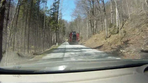 Driving on a forest road in austria behind a lowloader Stock Footage 127629062