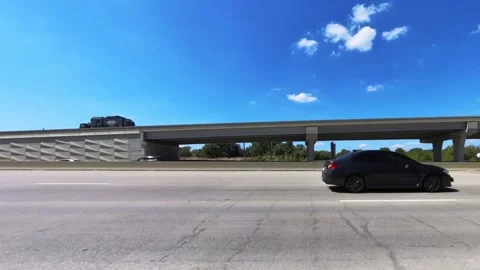 Driving on freeway through large highway interchange, blue sky, white clouds Vídeo Stock 253135785