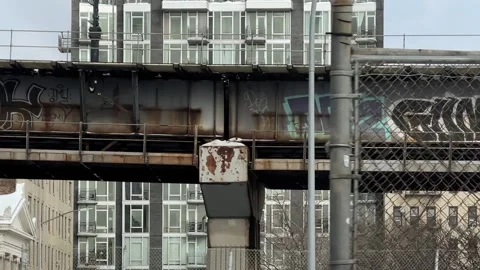 Driving by graffiti elevated subway train track platform Brooklyn New York City 스톡 동영상 148169641