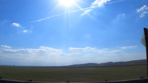 Driving by a grass sod farm on a bright sunny day - passenger window point Video stock 150411853