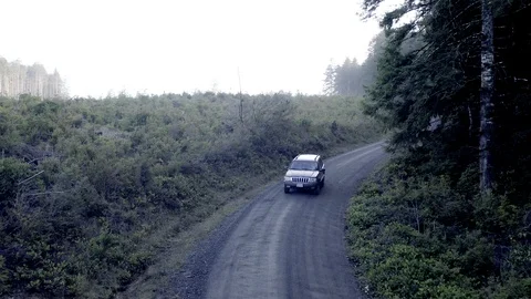 Driving A Grayish Black Jeep Model Car Across The Countryside Alongside Stock Footage 124396392