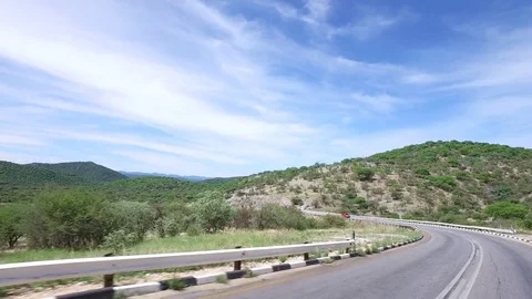 Driving in green landscape in Namibia. 4K stabilized footage from vehicle. 動画素材 83311075