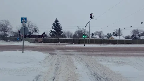 Driving on a green light and turning at an intersection in winter Stock Footage 266896396