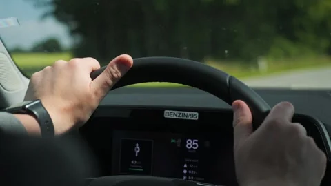 Driving with Hands on the Steering Wheel while observing the Digital Dash Stock Footage 316231588