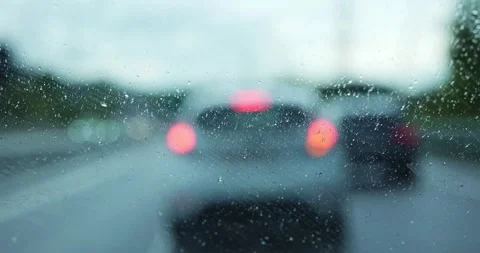 Driving in heavy rain with windshield wipers clearing water from the glass Stock Footage 336049372