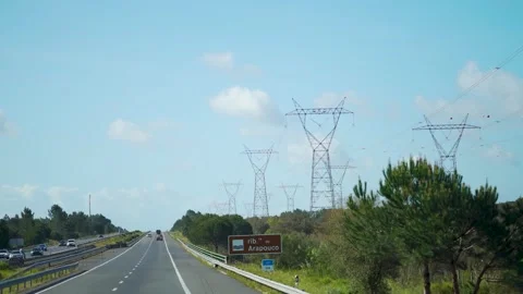 Driving on highway and looking at power lines next to it Stock Footage 273673470