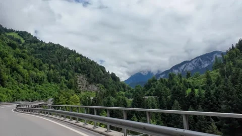 Driving Highway Curve with Alpine Valley Panorama Stock Footage 340375009