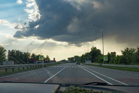 Driving on a highway with dramatic clouds 스톡 사진