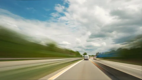 Driving on a highway with fluffy white clouds, time lapse Stock Footage 342722814