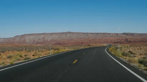 Driving On Highway Going Into Distance Through Desert On Background Of Red Rocks Stock Footage 120062366
