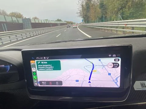 Driving on a highway with GPS navigation displayed on a car's dashboard scree Stock Photos