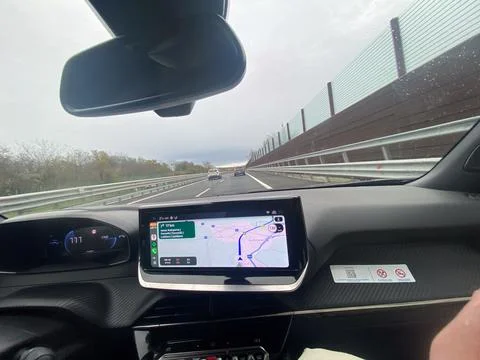Driving on a highway with navigation system showing route and speed on dash.. Stock Photos
