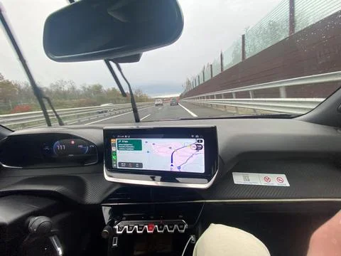 Driving on a highway with navigation system showing the route on a cloudy day Stock Photos