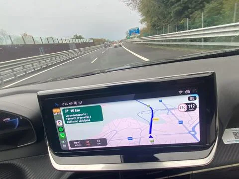 Driving on highway with navigation system showing route and speed limit Stock Photos