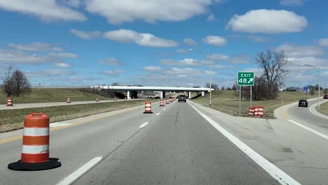 Driving on Highway Past Construction Pylons on a Sunny Day Stock Footage 332382409