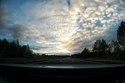 Driving on the highway at sunset. Stock Photos