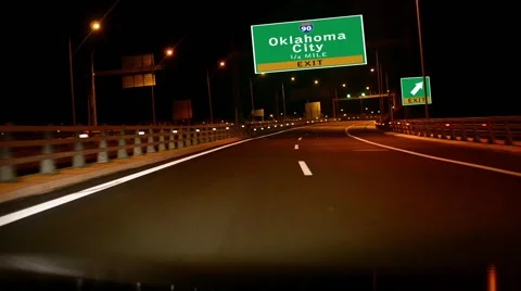 Driving on highway/interstate at night,  exit sign of the oklahoma ciry, okla Stock Footage 42229279