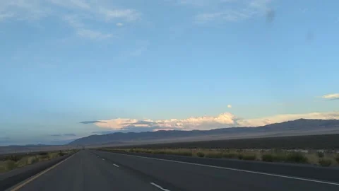 Driving I-80 Utah at dusk with desert mountains and colorful clouds Stock Footage 321506741
