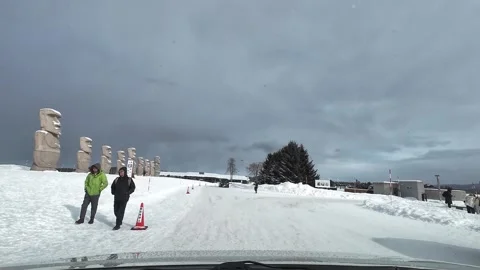 Driving inside Moai Statue Sapporo parking area with tourists winter 스톡 동영상 333205106