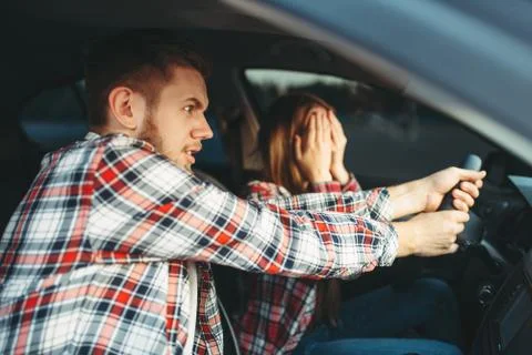 Driving Instructor helps driver to avoid accident Stock Photos