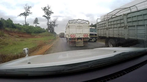 Driving with large work vehicles on road in Africa Video stock 107185700