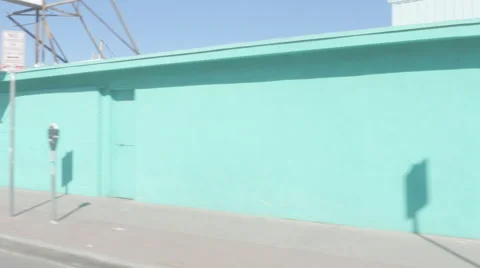 Driving by a Light Blue Wall in a Border Town Stock Footage 60455439