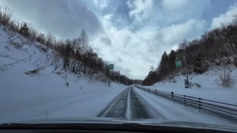 Driving in light snowfall on snowy highway winter POV empty road Video stock 333091318