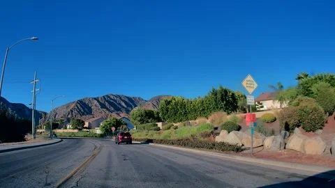 Driving in light traffic along a suburban road, Los Angeles, golden hour #2 Stock Footage 343475457