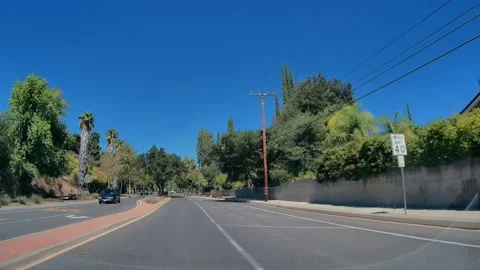 Driving in light traffic along a suburban road, Los Angeles Stock Footage 343475998