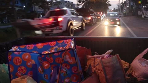 Driving on the loaded back of a car through the evening town Stock Footage 293085011