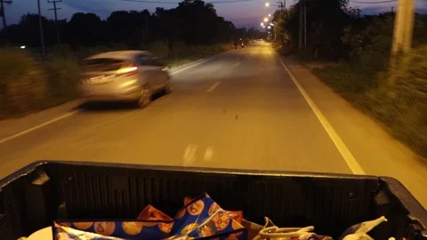 Driving on the loaded back of a car through the evening countryside Stock Footage 303343102