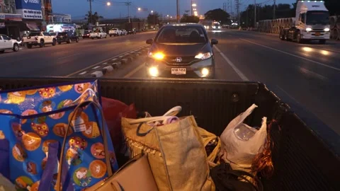 Driving on the loaded back of a car through the evening town Stock Footage 304528108