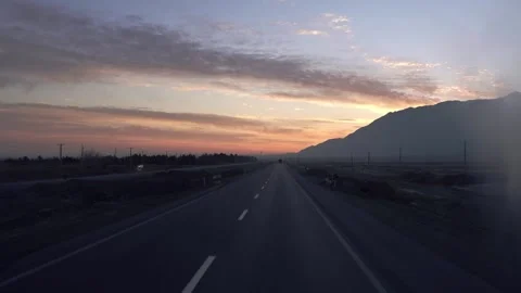 Driving on a long highway at sunrise Stock Footage 335955688