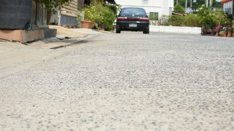 Driving a lowered car on a sloping car park Stock Footage 81385986