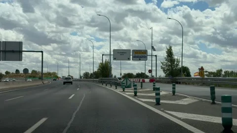 Driving on the M-11 highway in Madrid under a cloudy sky Видео 344572052