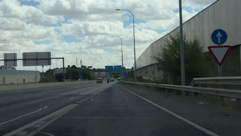 Driving on the Madrid M-30 ring road under a cloudy sky Stockbeeldmateriaal 344572051