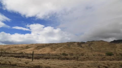 Driving Maui road, golden fields, blue sky Stock Footage 57403084