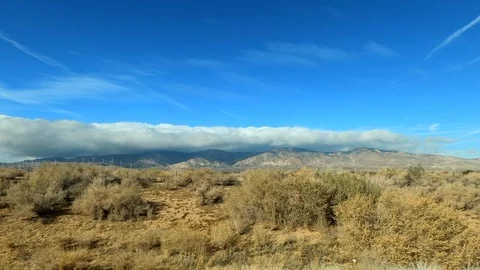 Driving by Mojave Desert Landscape with Mountain Background, Side View Stock Footage 123126953