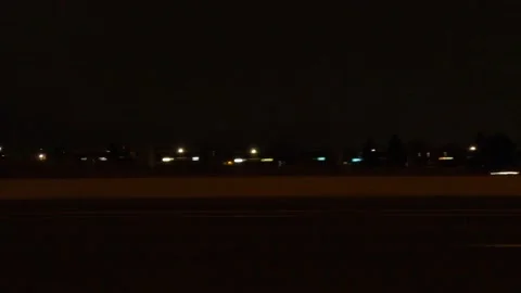 Driving motion shot with side view on dark city streets at night with buildings Video stock 149461481