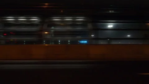 Driving motion shot with side view on dark city streets at night with buildings 動画素材 149463748