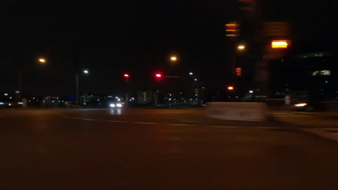 Driving motion shot with side view on dark city streets at night with buildings Stockbeeldmateriaal 149741895