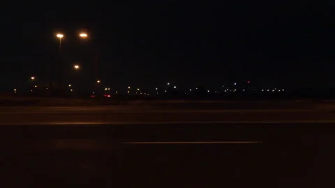 Driving motion shot with side view on dark city streets at night with buildings 動画素材 149744381