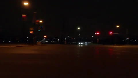 Driving motion shot with side view on dark city streets at night with buildings Stockbeeldmateriaal 149773065