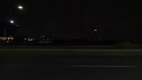 Driving motion shot with side view on dark city streets at night with buildings Vídeos de archivo 149775644