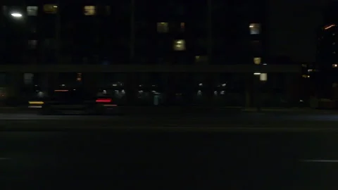 Driving motion shot with side view on dark city streets at night with buildings Vídeos de archivo 149776483